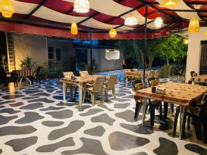 a dining room with tables and chairs on a patterned floor at Olive House in Pamukkale