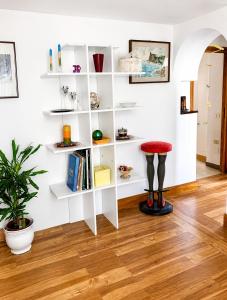 a room with white shelves and a stool at Guest House A Due Passi in Olbia