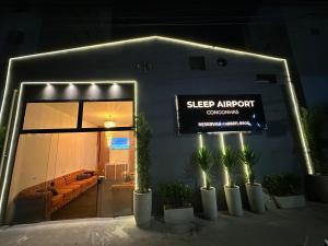 a sign on the side of a building with potted plants at sleep airport congonhas in São Paulo