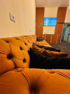 a row of brown leather couches in a room at sleep airport congonhas in São Paulo