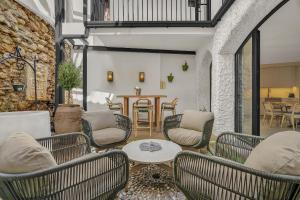 a living room with chairs and a table at Casa Azalia - Marbella Old Town by Finest Rentals in Marbella