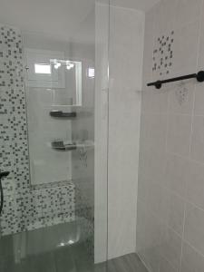 a shower with a glass door in a bathroom at Levanda House in Palekastron