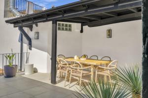 a wooden table and chairs on a patio at Casa Azalia - Marbella Old Town by Finest Rentals in Marbella