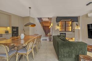 a living room with a wooden table and a couch at Casa Azalia - Marbella Old Town by Finest Rentals in Marbella