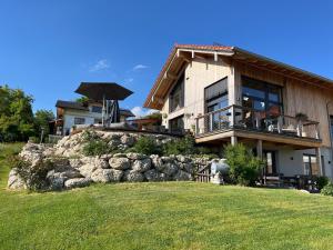 a house with an umbrella in front of it at Chalet Bergblick in Rimsting