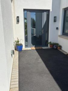 a door leading into a house with plants in front at Beyren House Guest Suite in Emo +4 photos
