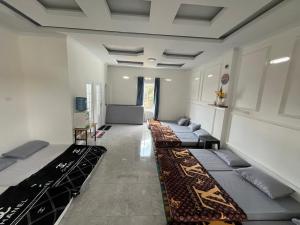 a room with a row of beds in it at Nok Homestay in Pangururan