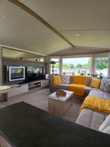 a large living room with a couch and a tv at 8 Moray View Seton Sands in Port Seton