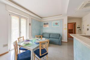 a living room with a table and chairs and a couch at Casa Norb Lerici - with Private Parking in Lerici