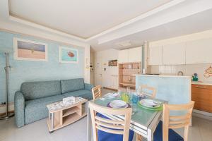 a living room with a table and a couch at Casa Norb Lerici - with Private Parking in Lerici