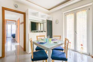 a dining room with a table with chairs and a television at Casa Norb Lerici - with Private Parking in Lerici