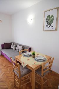 a living room with a table and a couch at Piadora in Banjol