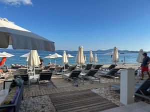 a group of chairs and umbrellas on a beach at Casa Christos in Barbati