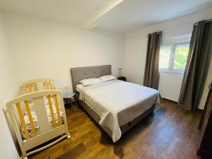 a bedroom with a bed and a window at Djekljak House in Virpazar