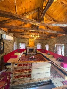 a living room with red couches and a table at Hasan Nika's Tower in Karicë