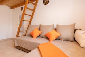 a couch with pillows and a ladder in a room at Holiday Home Grubišić in Mirce