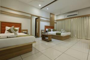 a hotel room with two beds at Hotel Decent in Bhāndu
