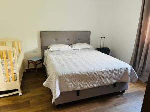 a bedroom with a bed and a crib in it at Djekljak House in Virpazar