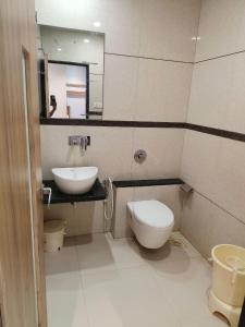 a bathroom with a sink and a toilet and a mirror at Hotel Decent in Bhāndu +77 photos