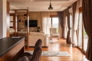 a living room with a couch and a tv at Villa Vitanika in Kunjići