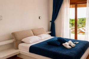 a bedroom with a bed with two towels on it at Villa Vitanika in Kunjići +21 photos