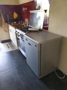 a kitchen with a stove and a counter top at La Flibuste in Andernos-les-Bains