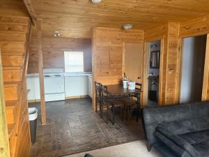 a kitchen and dining room with a table in a cabin at Rustic Inn in Park Rapids