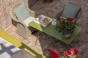 a table and chairs with a plate of food on it at Despotiko Hotel in Mikonos +72 photos