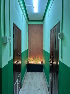 a hallway with two doors and a fishtank in the middle at Snehalata Lodge in Badarpur +4 photos