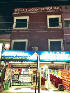 a store on a street in front of a building at Snehalata Lodge in Badarpur