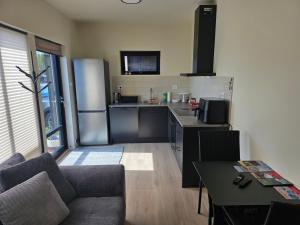 a kitchen with a couch and a table in a room at Fjordstay in Vennesla