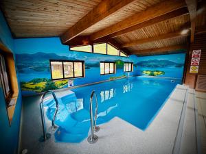 a swimming pool in a house with a mural at Lake District Woodland Cabin - Close to Ambleside & Langdale Valley in Ambleside