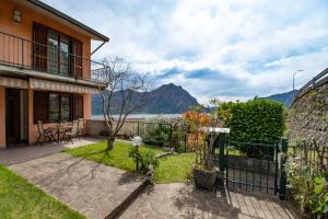 a house with a balcony with a view of the water at CASA di CRISTOF ISEO in Lovere