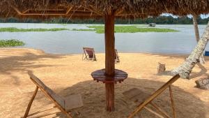a table and two chairs on a beach at Hôtel Lucia Grand Lahou in Grand-Lahou