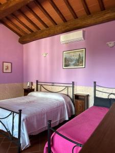 a bedroom with a bed and a purple wall at B&B Pizziconi Relax in Podere Modello +29 photos