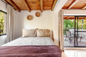 a bedroom with a bed and a balcony at Complejo Ermitazh in Valle Grande