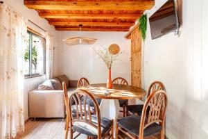 a dining room with a wooden table and chairs at Complejo Ermitazh in Valle Grande
