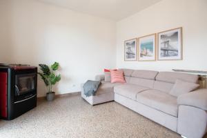 a living room with a couch and a tv at CASA di CRISTOF ISEO in Lovere
