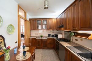 a kitchen with wooden cabinets and a counter top at CASA di CRISTOF ISEO in Lovere