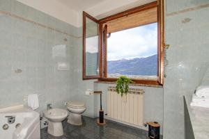 a bathroom with a toilet sink and a window at CASA di CRISTOF ISEO in Lovere +37 photos