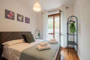 a bedroom with a bed with two towels on it at CASA di CRISTOF ISEO in Lovere