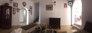 a living room with white walls and a fireplace at mithwood in Nuwara Eliya