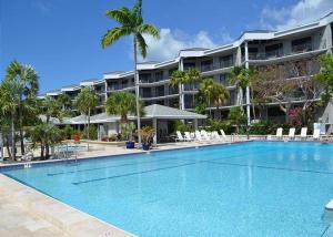 a large swimming pool in front of a large building at Nautical Adventures in Paradise in Key West