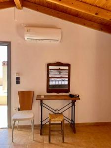 a table and chair in a room with a mirror at Samos Panorama Hills in Pythagoreio