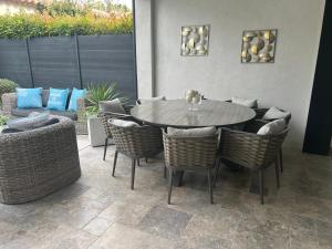 a dining table and chairs in a patio at Superbe villa golfe st Tropez in Sainte-Maxime