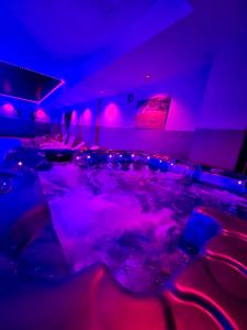 a room with a pool with purple lights at Vistamar Luxury Apartments By DLV -Adults Only- in Villajoyosa +148 photos