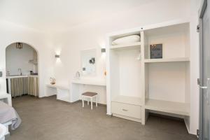 a bedroom with white cabinets and a bed and a desk at Galaxy studios in Astypalaia +110 photos