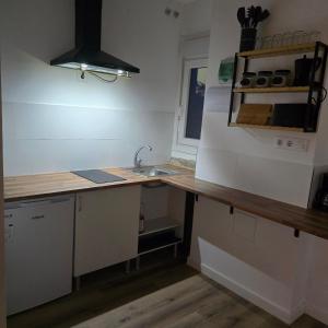 a kitchen with a sink and a counter top at Casa a Figueira in Pungín