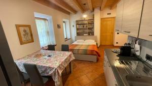 a small room with a bed and a table in it at Appartamenti Bion in Levico Terme