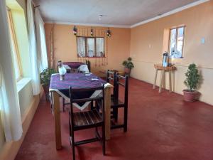 a dining room with a table and chairs at Musiña Lodge in Ocosuyo